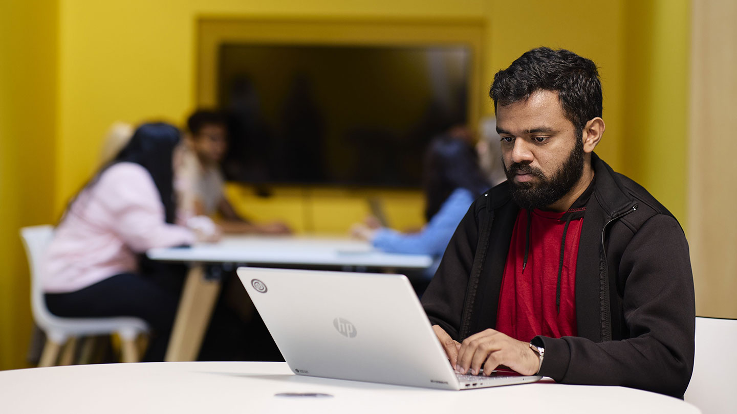 A student working on a laptop.